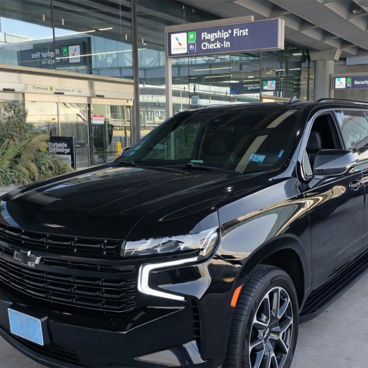 Black SUV at airport terminal curbside